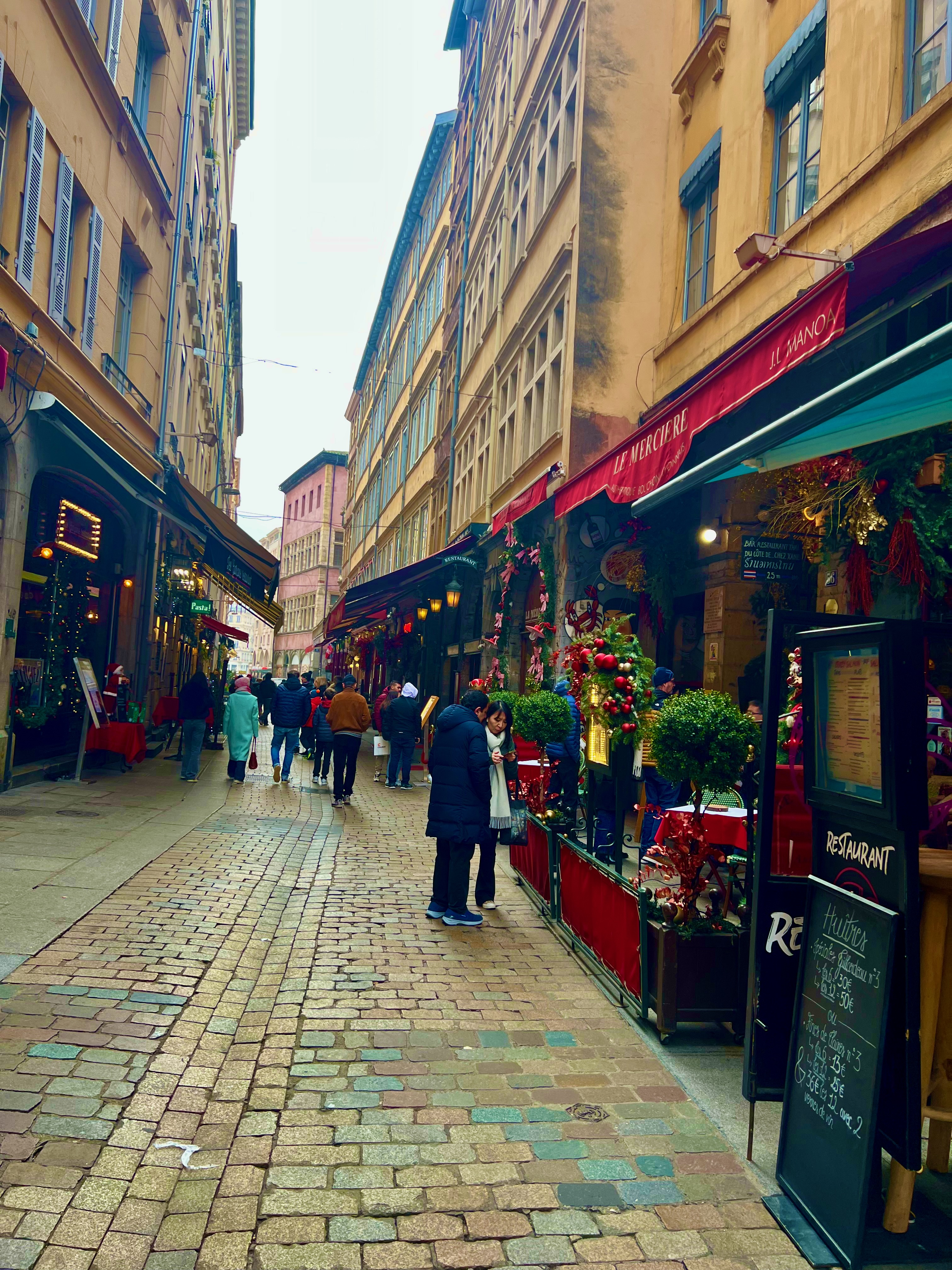 Narrow cobblestone street lined with restaurants